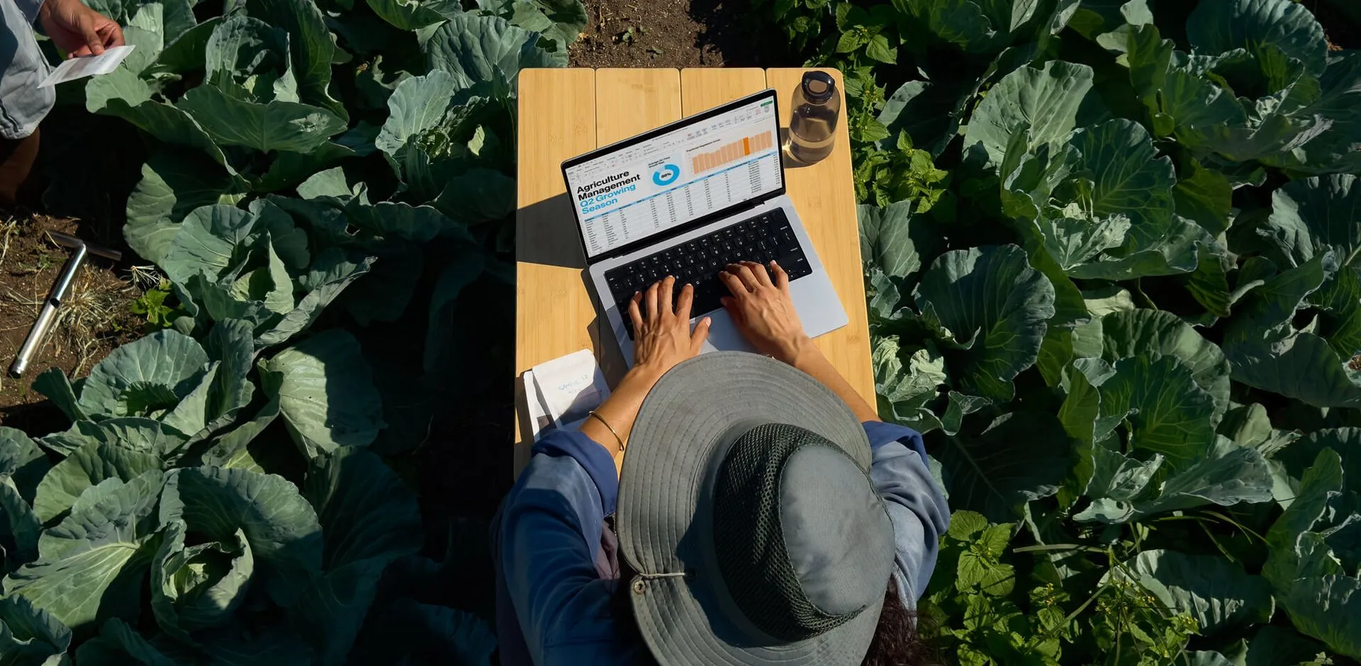 Person working outdoors with Apple technology